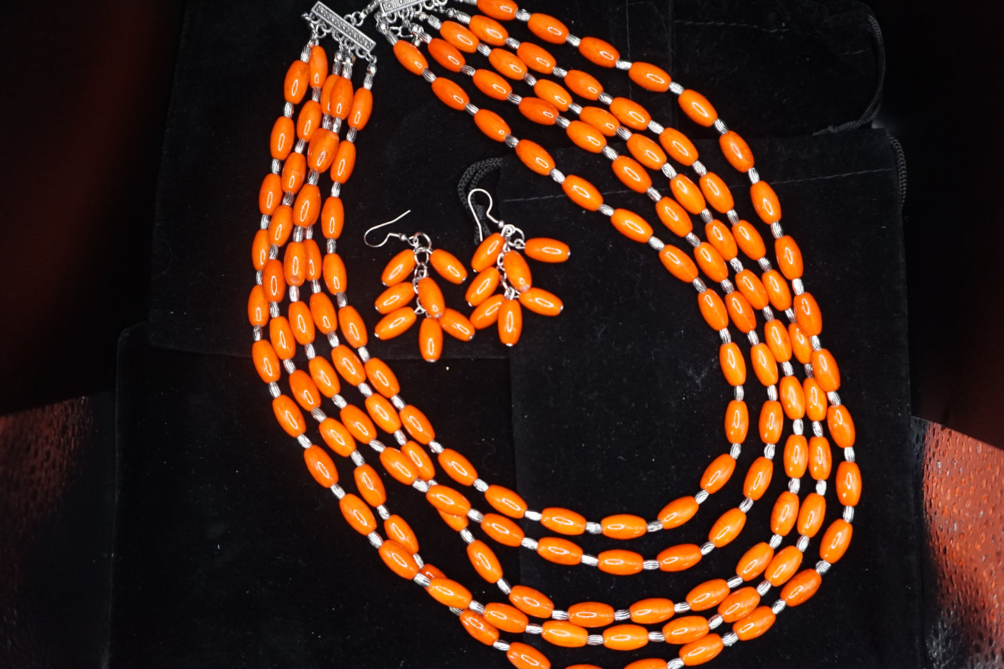 Orange beaded necklace with matching earrings